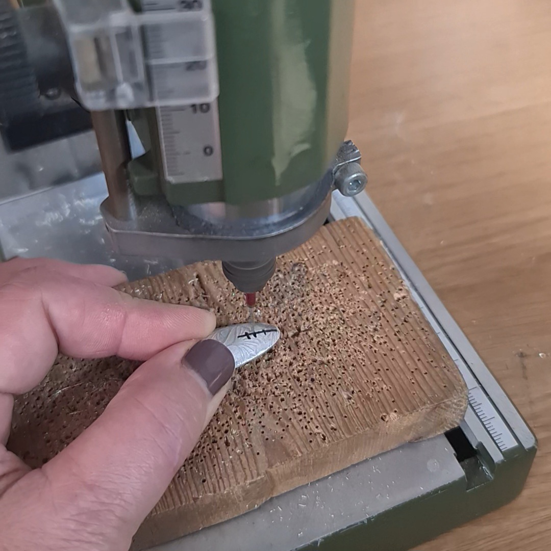 image shows a hole being drilled in the back of the oval form